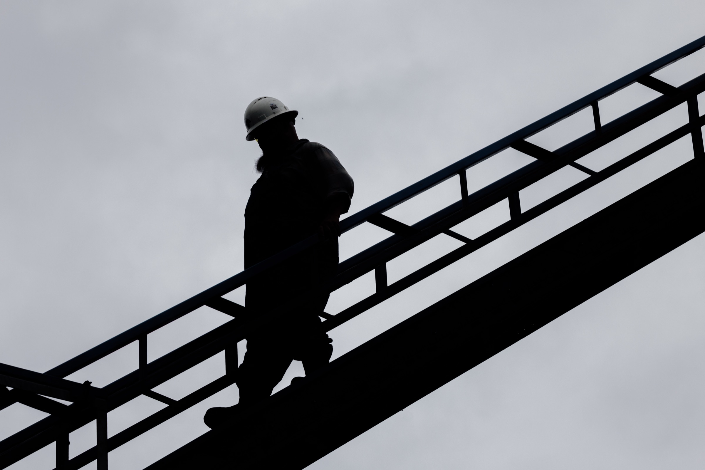 Silhouette of a crew member climbing stairs