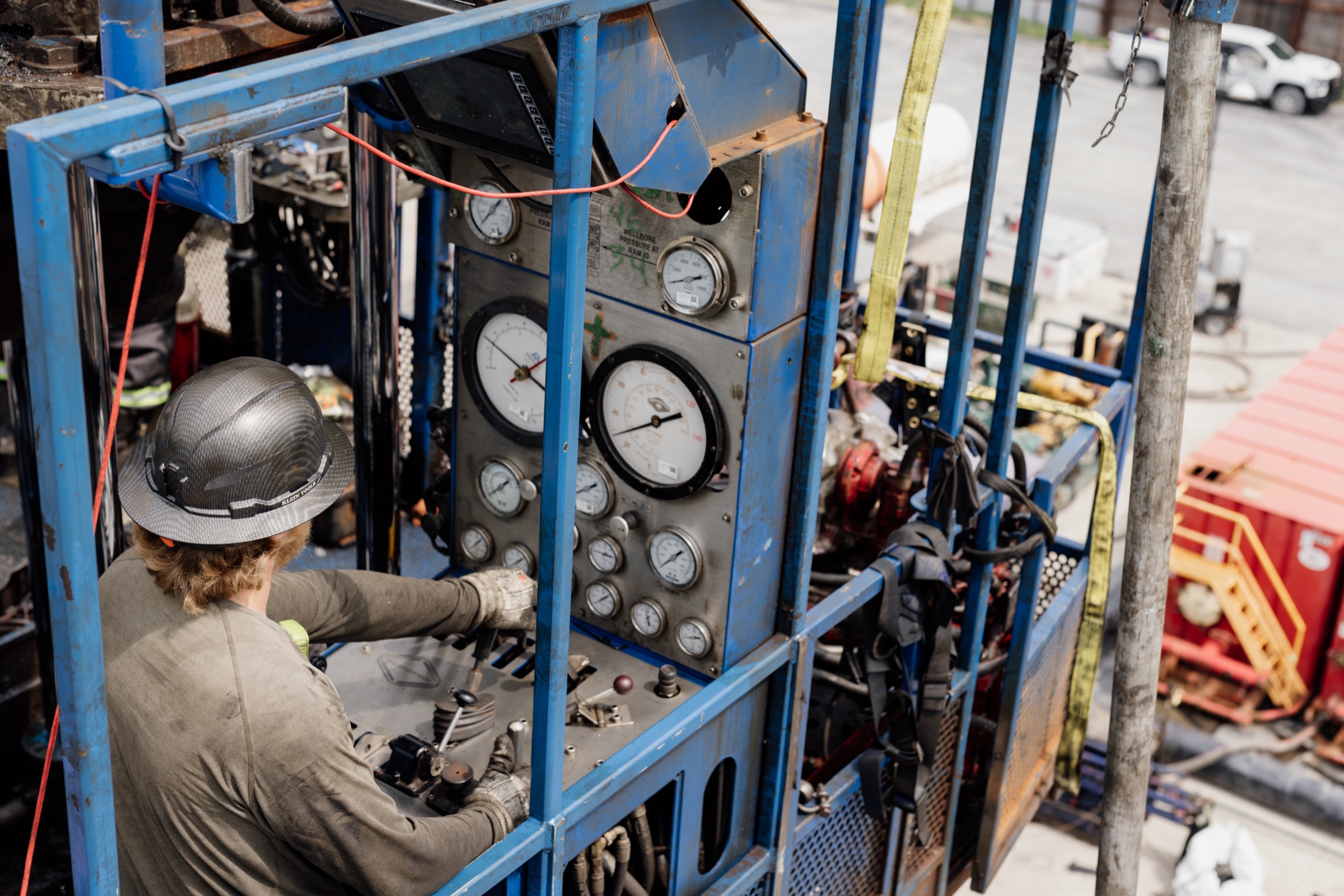 Crew member reading gauges on a control panel